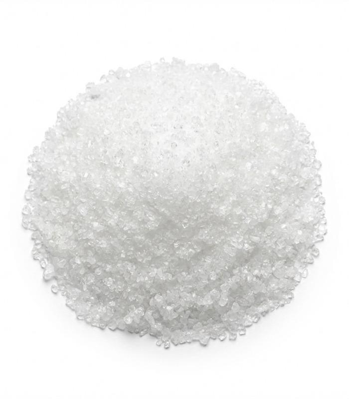 Metabisulfito sódico, 1Kg, Ref: 0003-1K, mostrando un montón de cristales blancos granulares sobre fondo blanco.