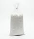 Bolsa transparente sellada con un kilogramo de polvo blanco fino, Carbonato de Calcio Técnico.