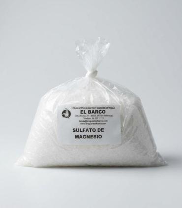 Bolsa transparente de 1Kg con sulfato de magnesio blanco cristalino, etiquetada con detalles del producto.